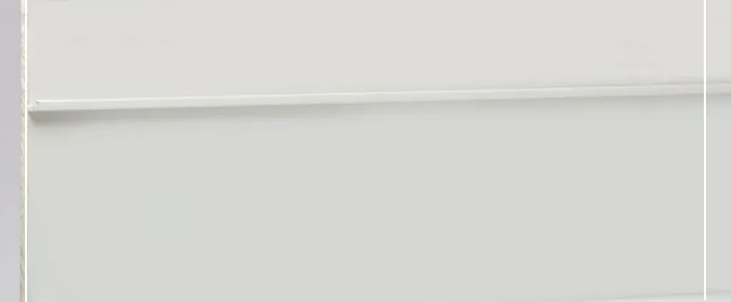A close-up of a minimalistic white wall panel featuring two horizontal grooves, creating a sleek and modern aesthetic with a light, airy tone.
