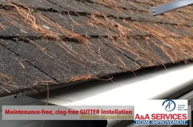 Alt text: "Roof with pine needles and a newly installed, maintenance-free gutter system. Text reads: 'Maintenance-free, clog-free GUTTER installation, Andover, Massachusetts. A&A Services, Home Improvement.'"