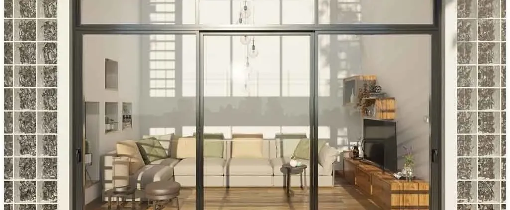 Modern living room with large glass doors, beige sectional sofa with green cushions, and wooden media console. Warm, inviting ambiance with soft lighting.