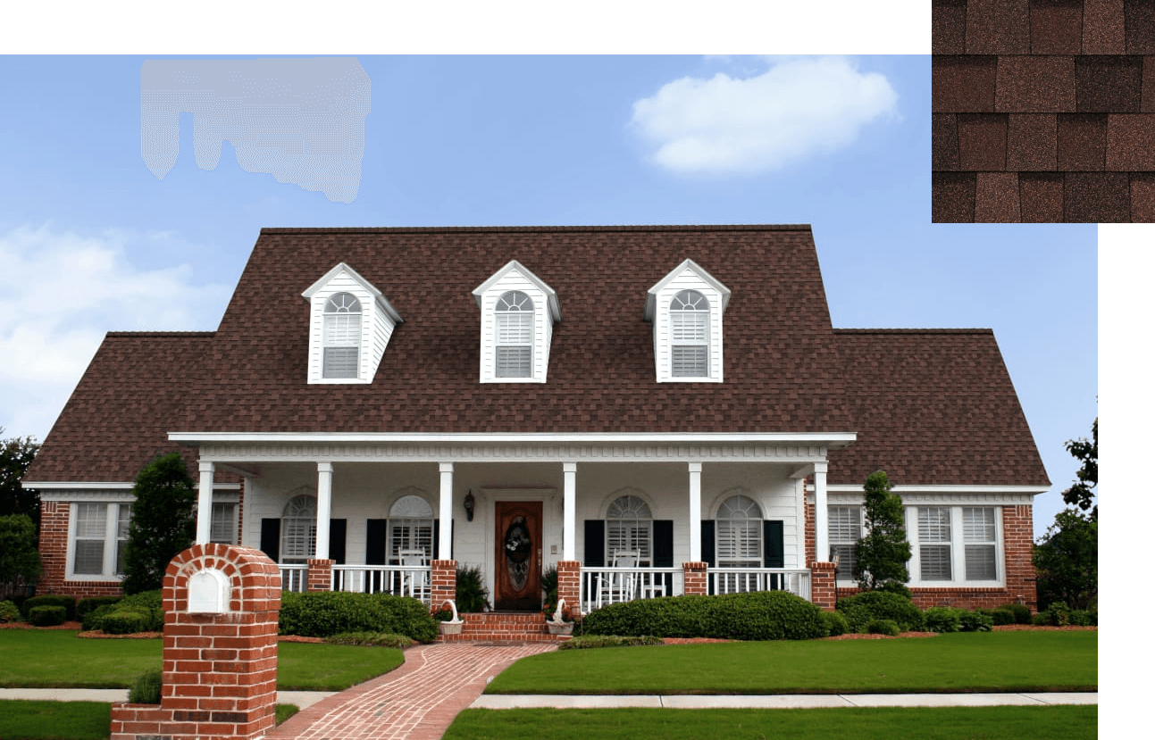 A charming two-story brick house with brown shingles, white pillars, and a lush lawn. The foreground features a red brick mailbox and a pathway leading to the porch.