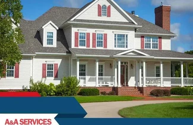 Large white colonial-style house with red shutters and brick foundation. Surrounded by green lawn and trees, a "A&A Services" banner overlays the bottom.